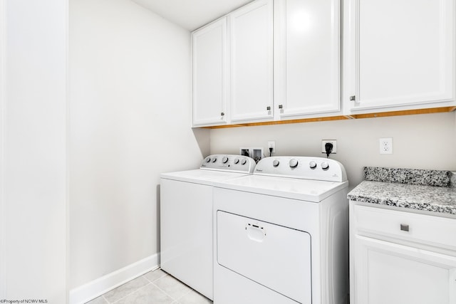 laundry room featuring light tile patterned flooring, independent washer and dryer, and cabinets