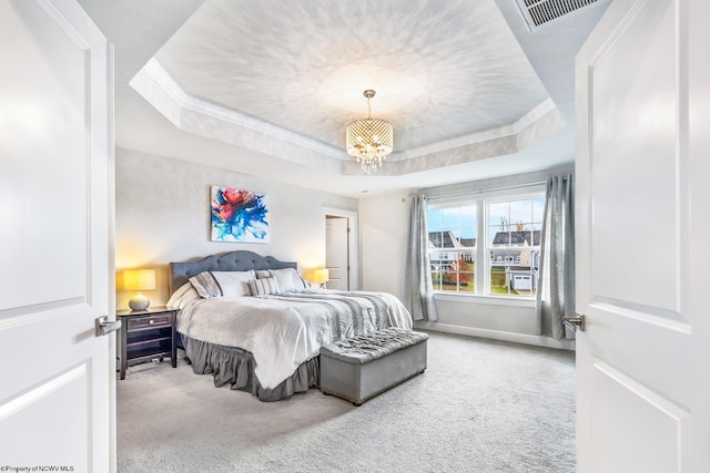 carpeted bedroom with crown molding, a raised ceiling, and an inviting chandelier