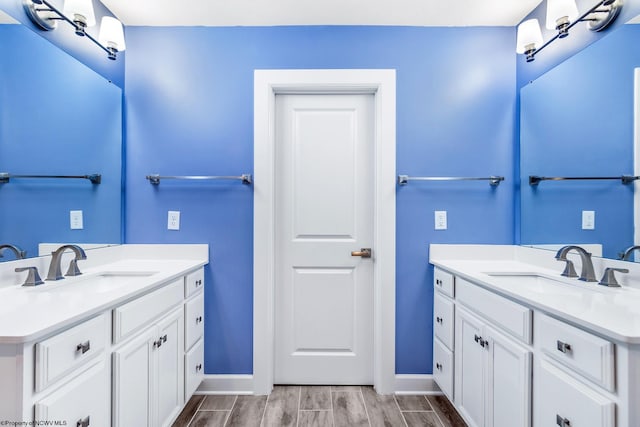 bathroom with vanity and wood-type flooring