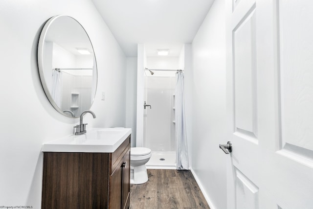 bathroom with vanity, hardwood / wood-style floors, curtained shower, and toilet