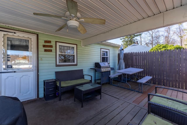 wooden terrace featuring ceiling fan and grilling area