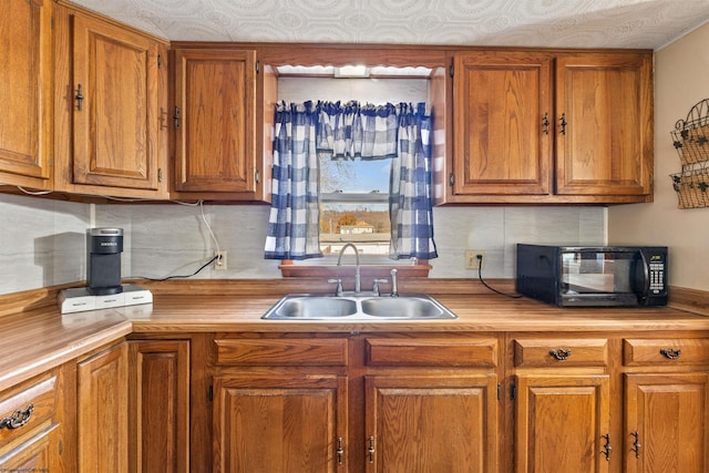 kitchen featuring sink and decorative backsplash