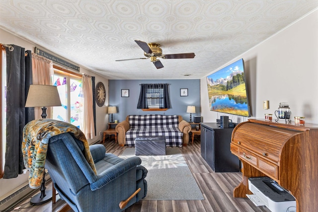 living room with ceiling fan, a textured ceiling, dark hardwood / wood-style floors, crown molding, and baseboard heating