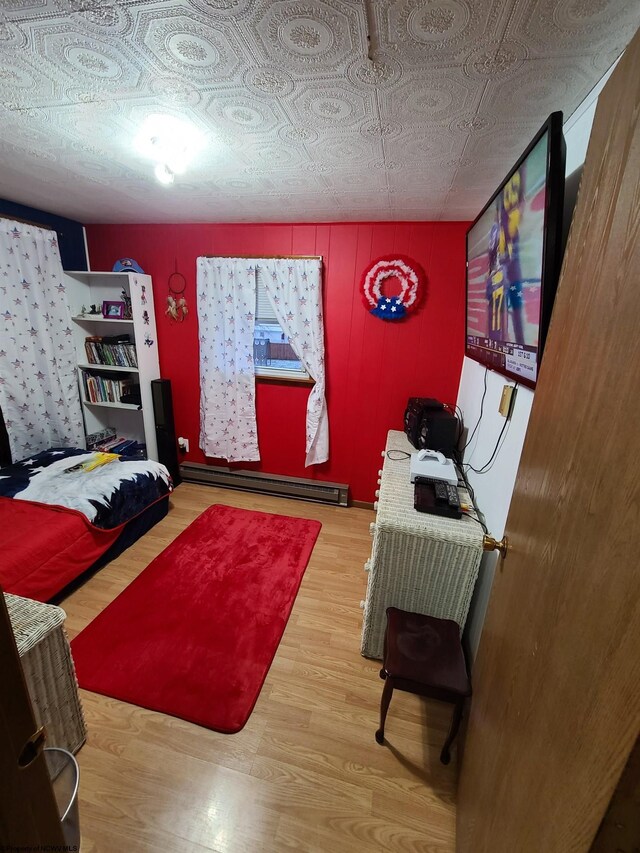 living room with wood-type flooring and a baseboard radiator