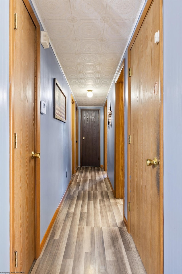 corridor with wood-type flooring