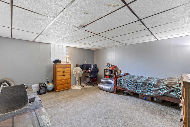 bedroom featuring light colored carpet and a paneled ceiling