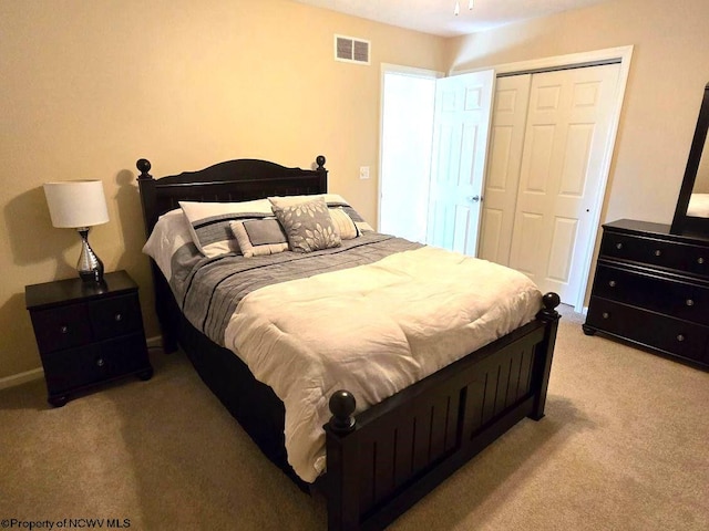 bedroom featuring a closet and light colored carpet