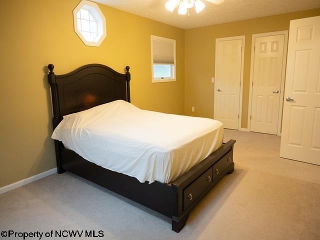 bedroom featuring ceiling fan and light colored carpet