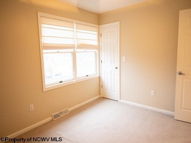 unfurnished bedroom with light carpet