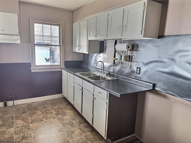 kitchen with extractor fan, sink, and white cabinets