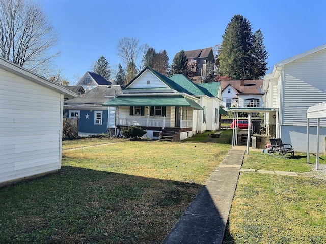 rear view of house featuring a yard