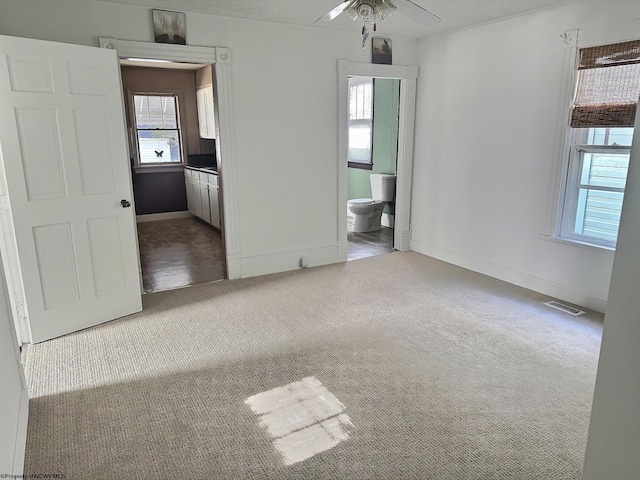 empty room with light carpet and ceiling fan