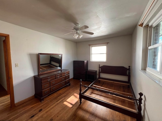 bedroom with ceiling fan and wood-type flooring