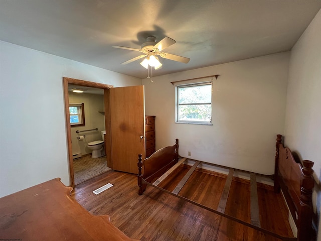 bedroom with ceiling fan, wood-type flooring, and ensuite bathroom