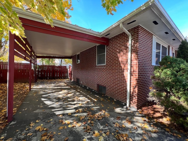 view of property exterior with a carport