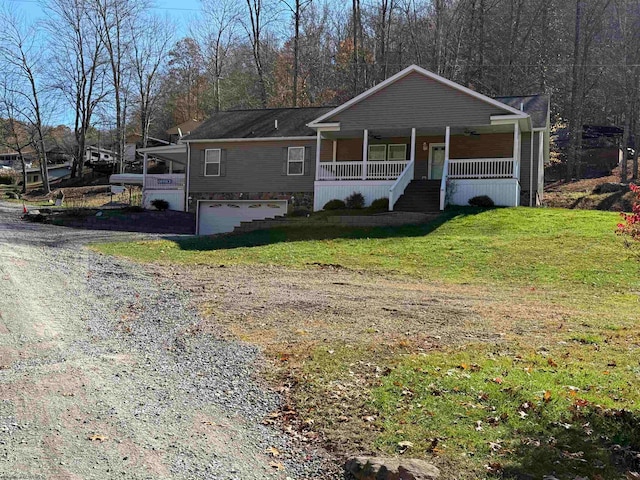 view of front of house featuring a garage, a front lawn, and a porch