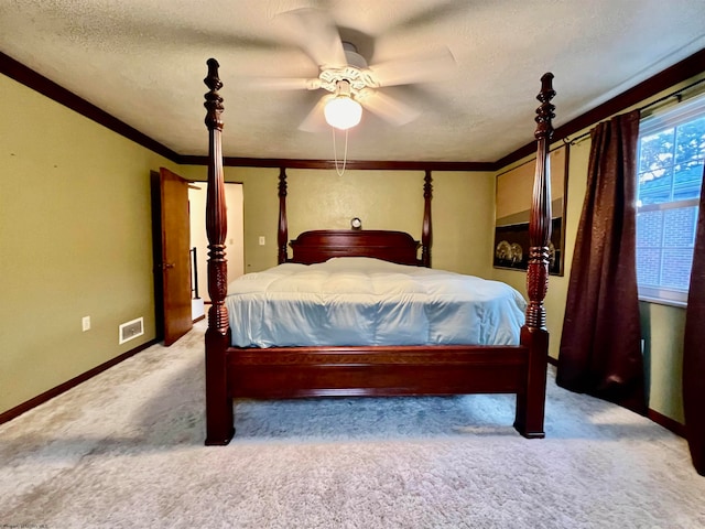 bedroom with ceiling fan, carpet flooring, a textured ceiling, and ornamental molding