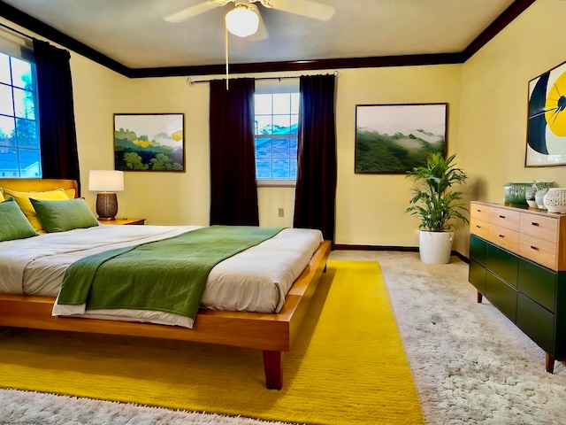 bedroom featuring ceiling fan, crown molding, and multiple windows