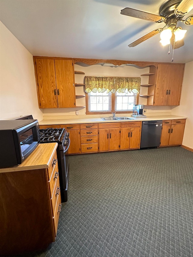 kitchen featuring appliances with stainless steel finishes, sink, dark carpet, and ceiling fan