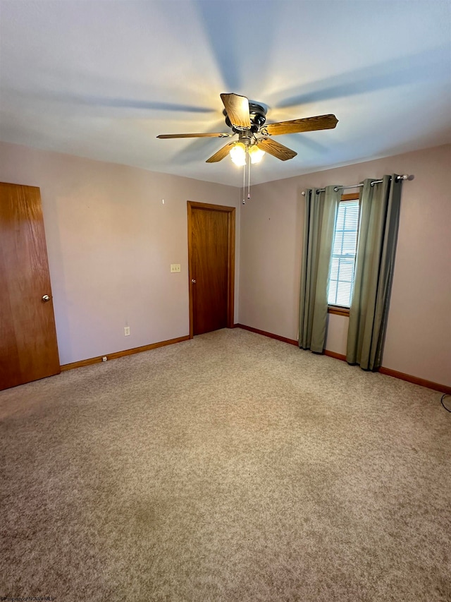 empty room with carpet and ceiling fan