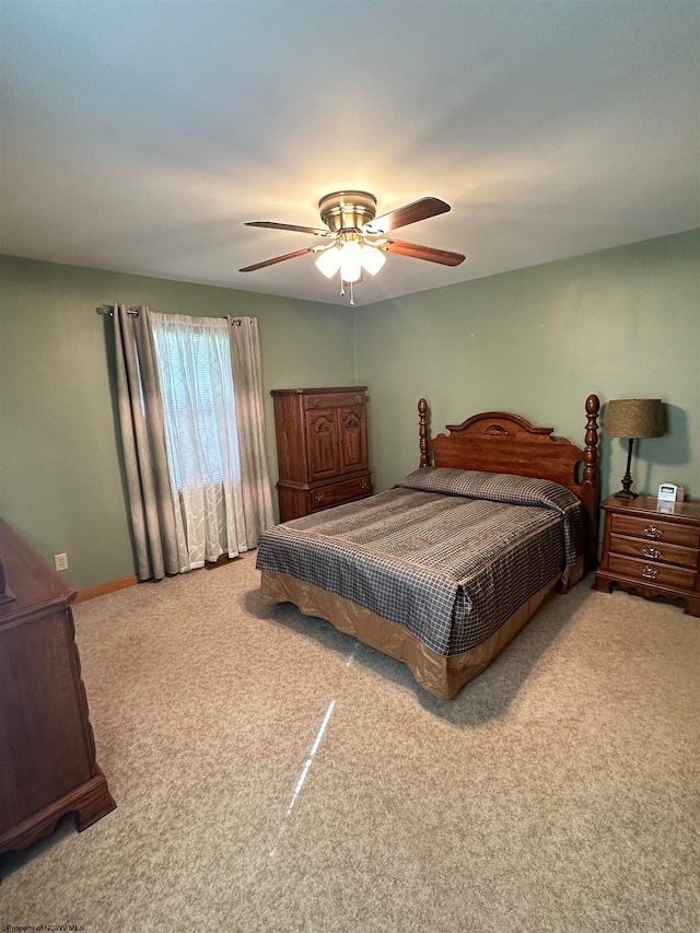 bedroom with ceiling fan and light colored carpet