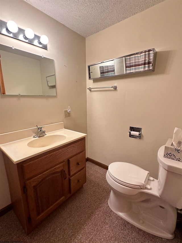 bathroom featuring vanity, toilet, and a textured ceiling