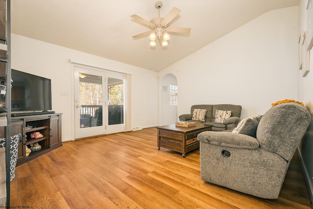 living room with vaulted ceiling, hardwood / wood-style flooring, and ceiling fan