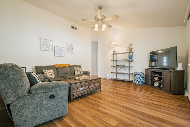 living room featuring high vaulted ceiling, light hardwood / wood-style floors, and ceiling fan