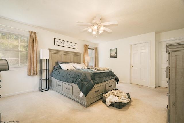 bedroom with light colored carpet and ceiling fan