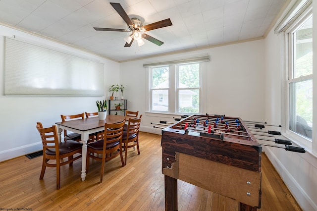 recreation room featuring light wood-type flooring, ceiling fan, and crown molding