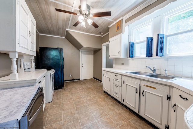 kitchen featuring white cabinetry, stainless steel appliances, tasteful backsplash, and wooden ceiling