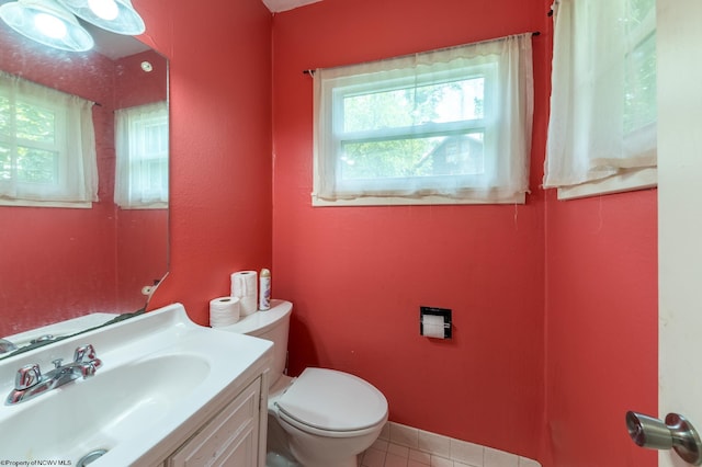 bathroom featuring toilet, vanity, and tile patterned floors