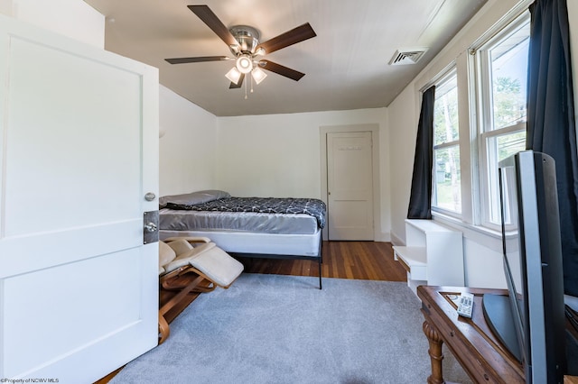 bedroom with ceiling fan and dark hardwood / wood-style floors