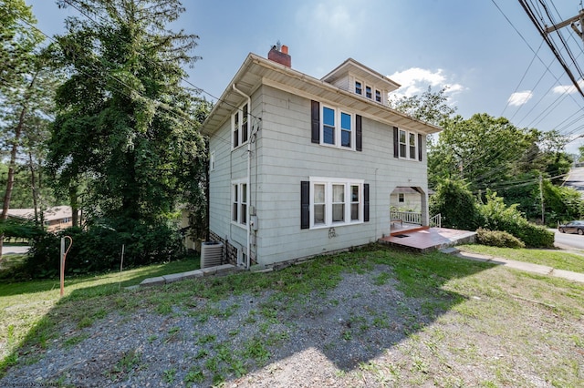 view of front facade with central AC unit and a front lawn