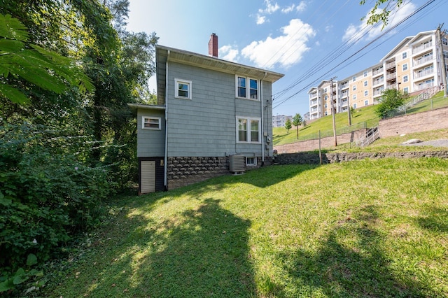 back of house with a lawn