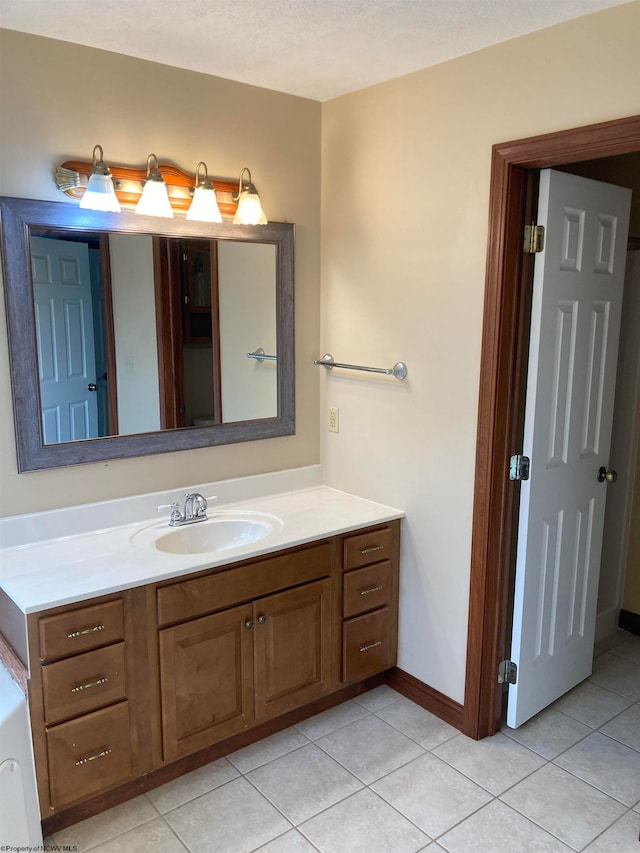 bathroom with vanity, a textured ceiling, and tile patterned floors