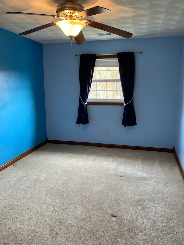 spare room with carpet and ceiling fan