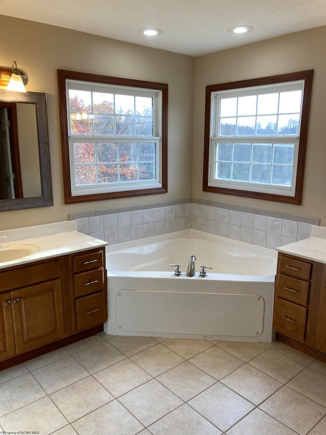 bathroom featuring a tub, tile patterned flooring, and vanity