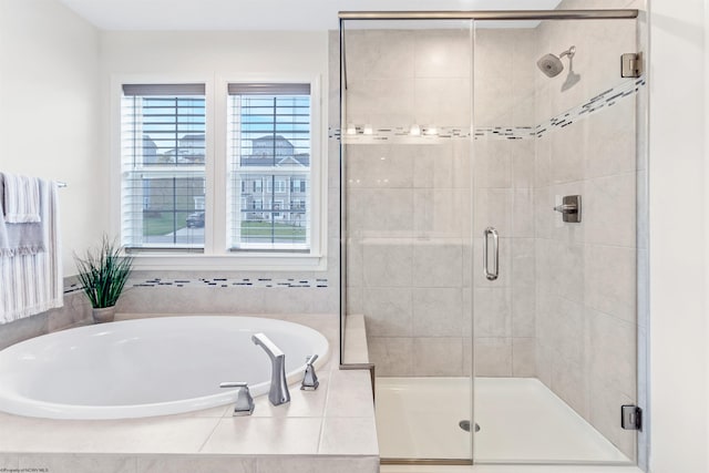 bathroom featuring shower with separate bathtub