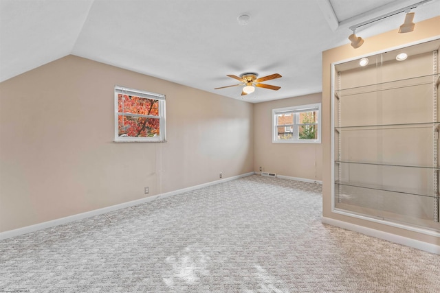 interior space with lofted ceiling, ceiling fan, and carpet floors