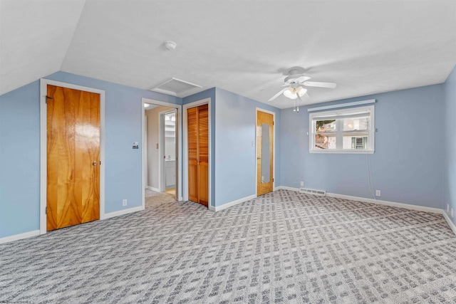 unfurnished bedroom featuring lofted ceiling, light colored carpet, and ceiling fan