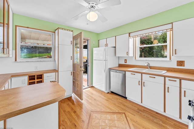 kitchen featuring butcher block countertops, white fridge, sink, white cabinets, and dishwasher