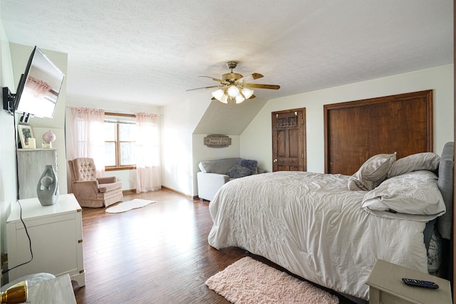 bedroom featuring wood-type flooring, ceiling fan, and a textured ceiling