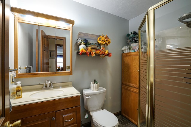 bathroom with toilet, tile patterned flooring, a textured ceiling, an enclosed shower, and vanity