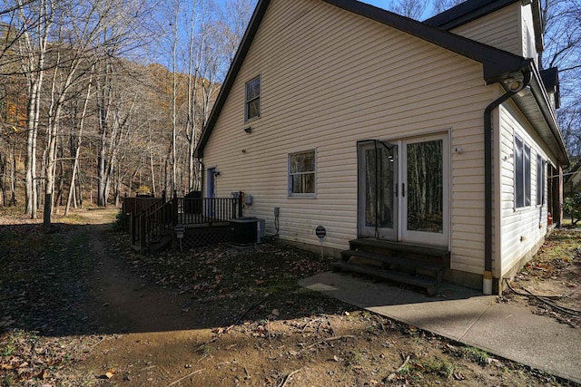 back of property featuring a wooden deck