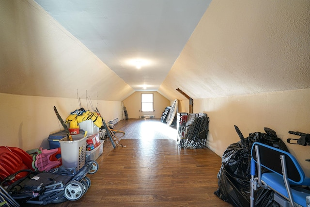 additional living space featuring hardwood / wood-style flooring and lofted ceiling