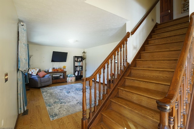 stairs with hardwood / wood-style floors