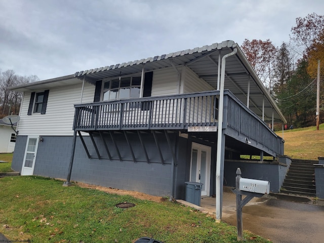 view of home's exterior featuring a yard and a wooden deck