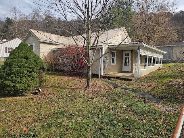 exterior space with a front lawn and a porch