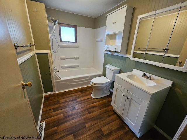 full bathroom featuring hardwood / wood-style flooring, vanity, toilet, and bathtub / shower combination